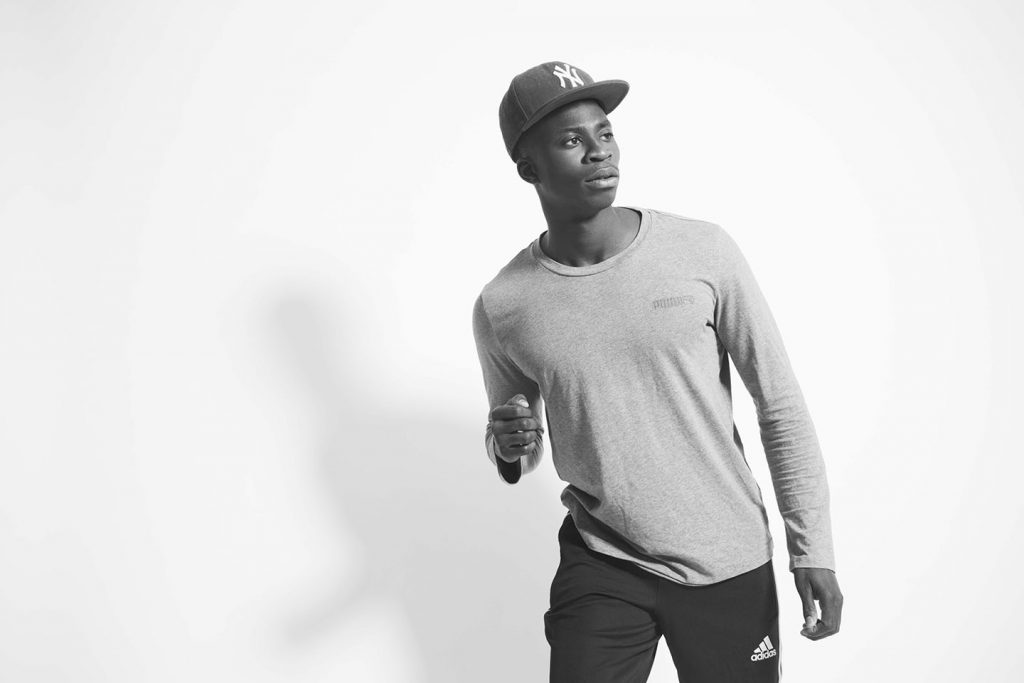 Black athlete in a cap and sweatshirt.