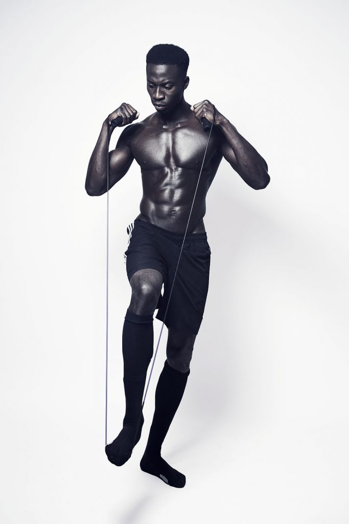 Shirtless black athlete.